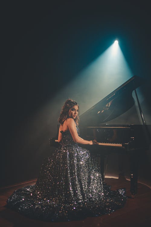 Free Woman Sitting Near Piano Stock Photo